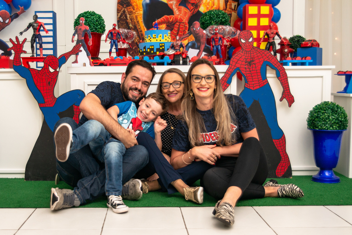 Foto de família em frente à decoração de festa do homem aranha