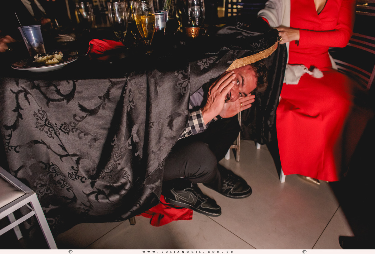 convidado se escondendo embaixo da mesa