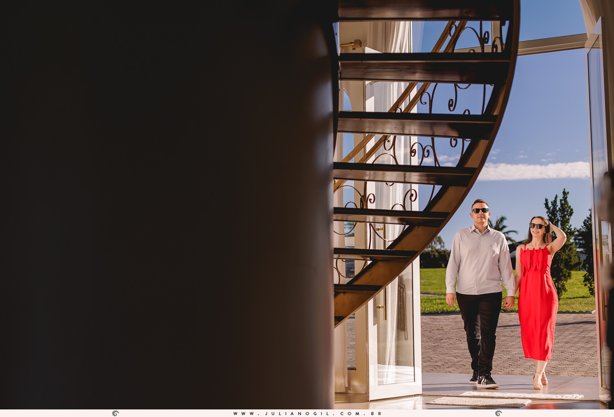 noivos entrando no chalé usando óculos escuros, contorno feito pela escada em espiral