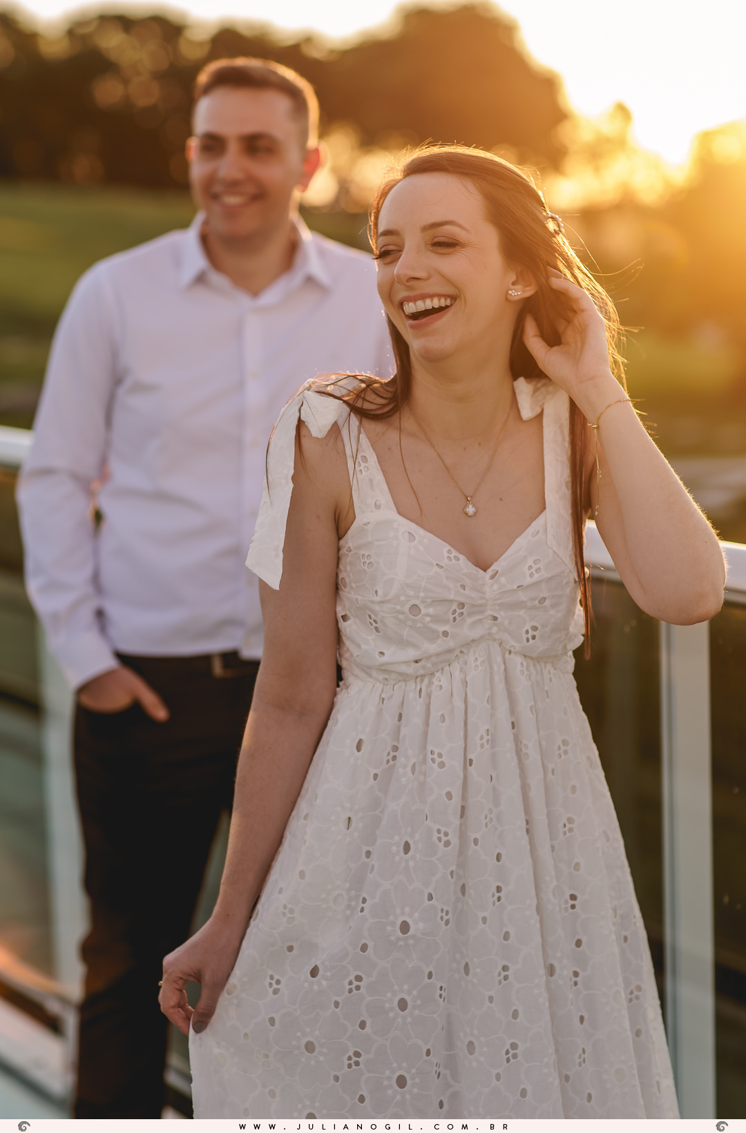 casal se olhando com a luz do sol batendo neles ao fundo no pôr do sol