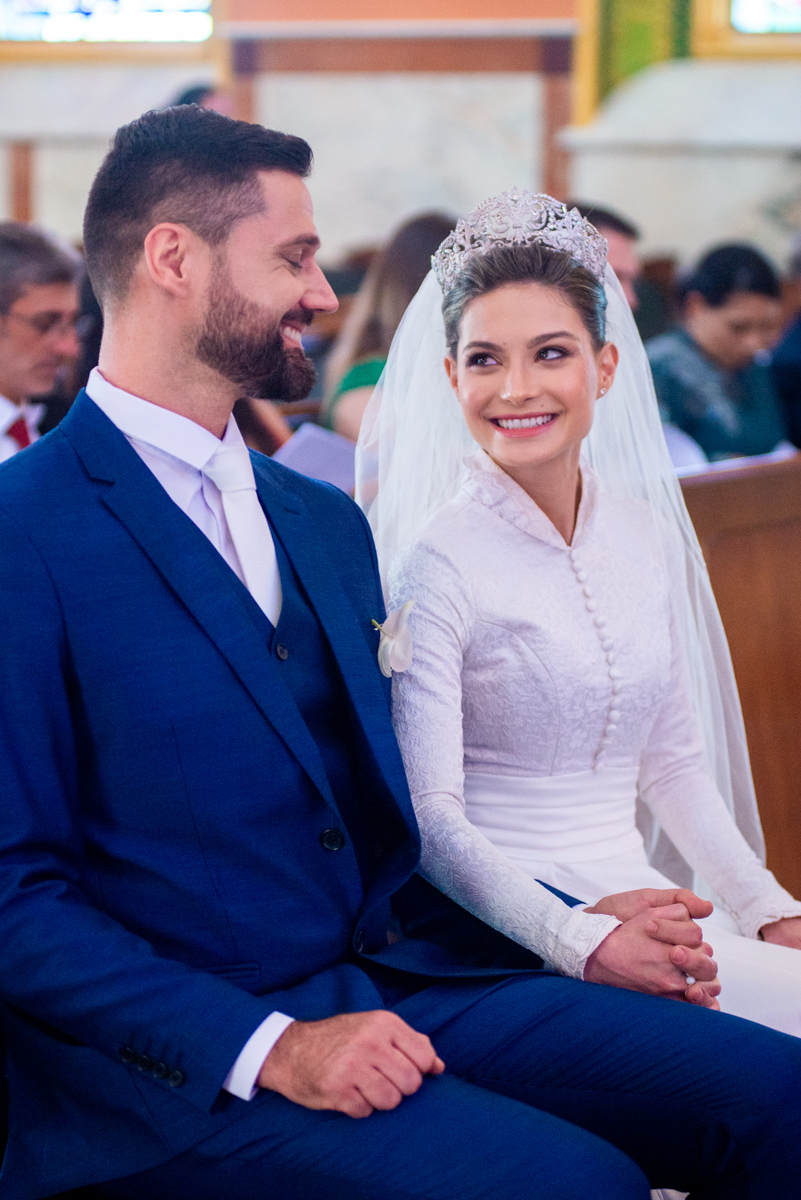 Noiva sorri para o noivo com a realização de um sonho de casamento.