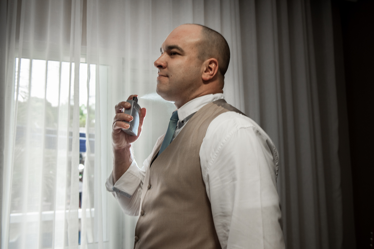 Noivo passando o perfume antes de seu casamento.