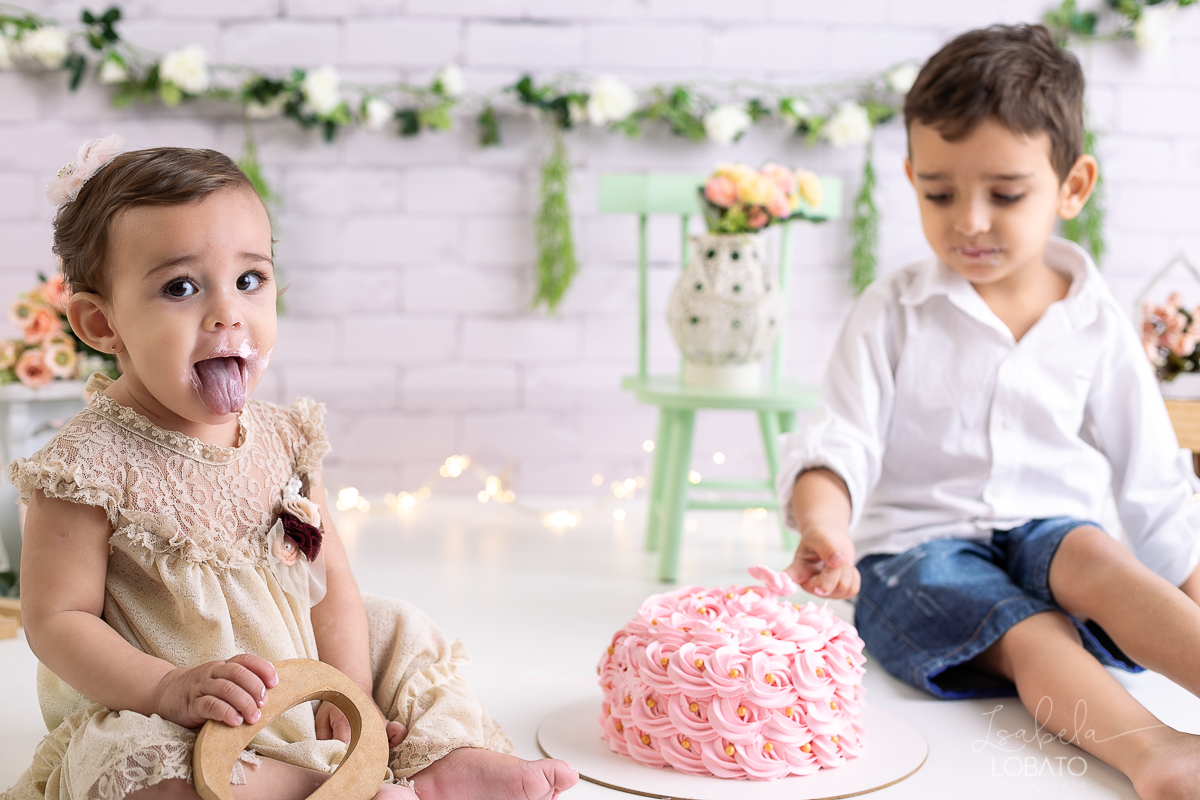 ensaio-fotografico-da-hora-do-bolo-esmagando-o-bolo-smash-the-cake-one-bebe-de-um-ano-acompanhamento-fotografico-de-bebes-fotografa-especializada-em-criancas-em-barbacena-isabela-lobato-fotografia-fundo-fotografico-de-smash-the-cake-cenario-fotografico