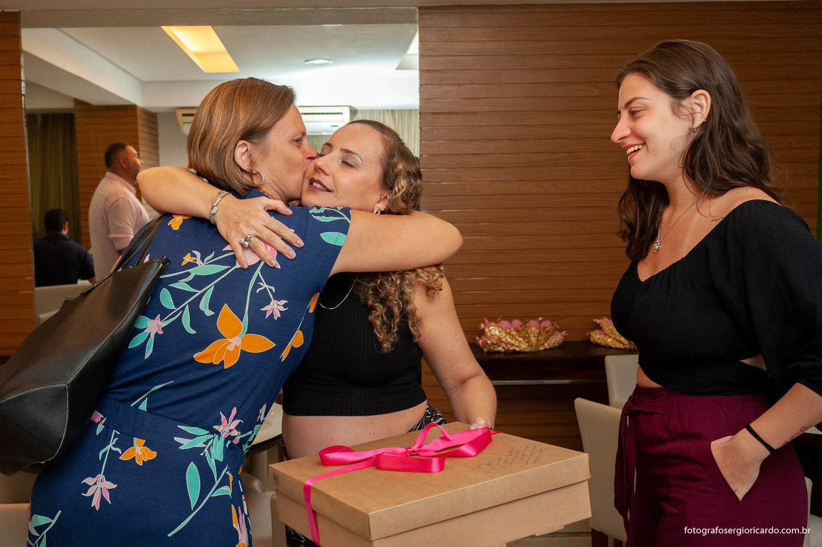 foto da gestante recebendo presente durante o chá de fralda com tema dunbo baby na cor rosa