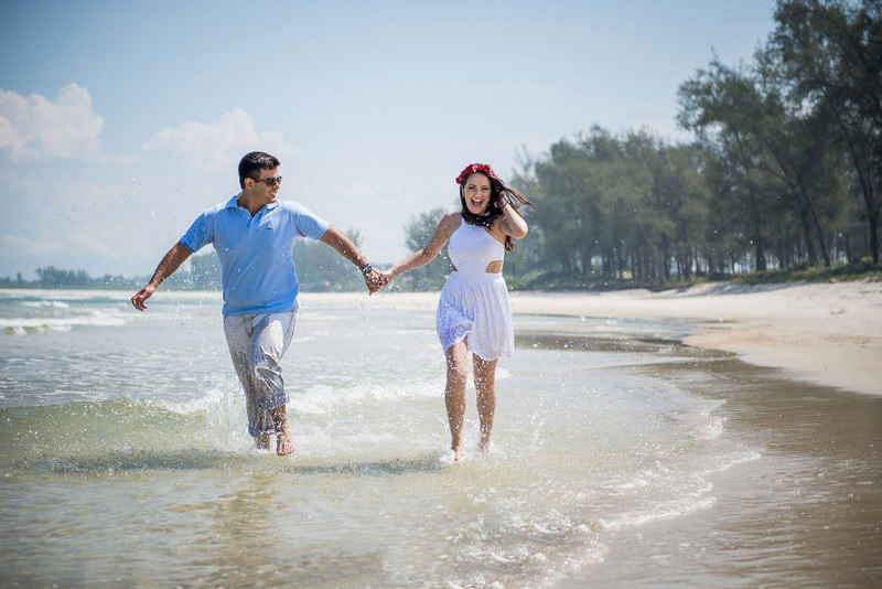 Isa e Thiago correndo de mãos dadas na praia da Restinga da Marambaia no ensaio pré-casamento no Rio de janeiro