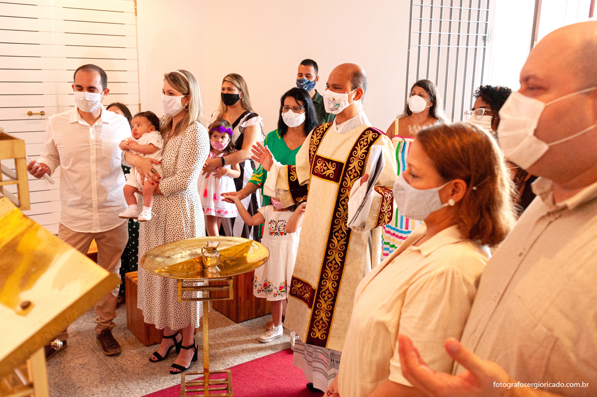 Fotografia do padre e convidados durante cerimônia o batismo na Capela de Nossa Senhora Aparecida no Cristo Redentor localizado no Morro do Corcovado no Rio de Janeiro