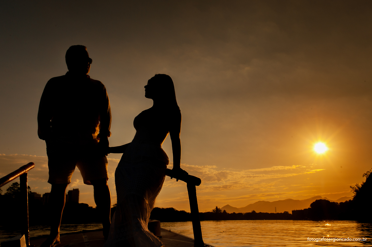 Fotografia de ensaio de casal em passeio de barco pela Ilha da Gigóia com pôr do sol na Barra da Tijuca no Rio de Janeiro