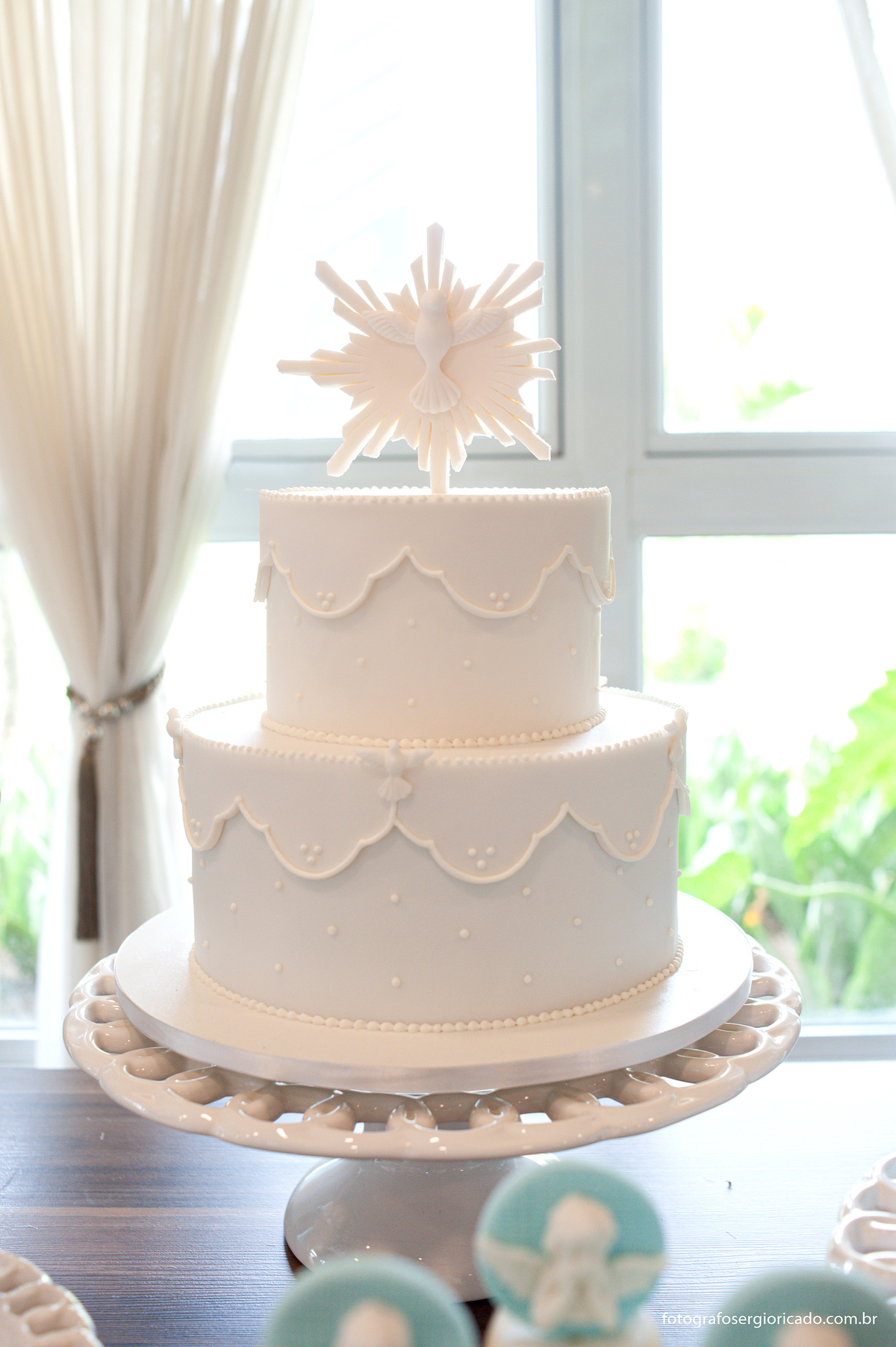 Fotografia do bolo de batizado de menino feita por Brenda Rebelo em tom azul claro na Barra da Tijuca no Rio de Janeiro