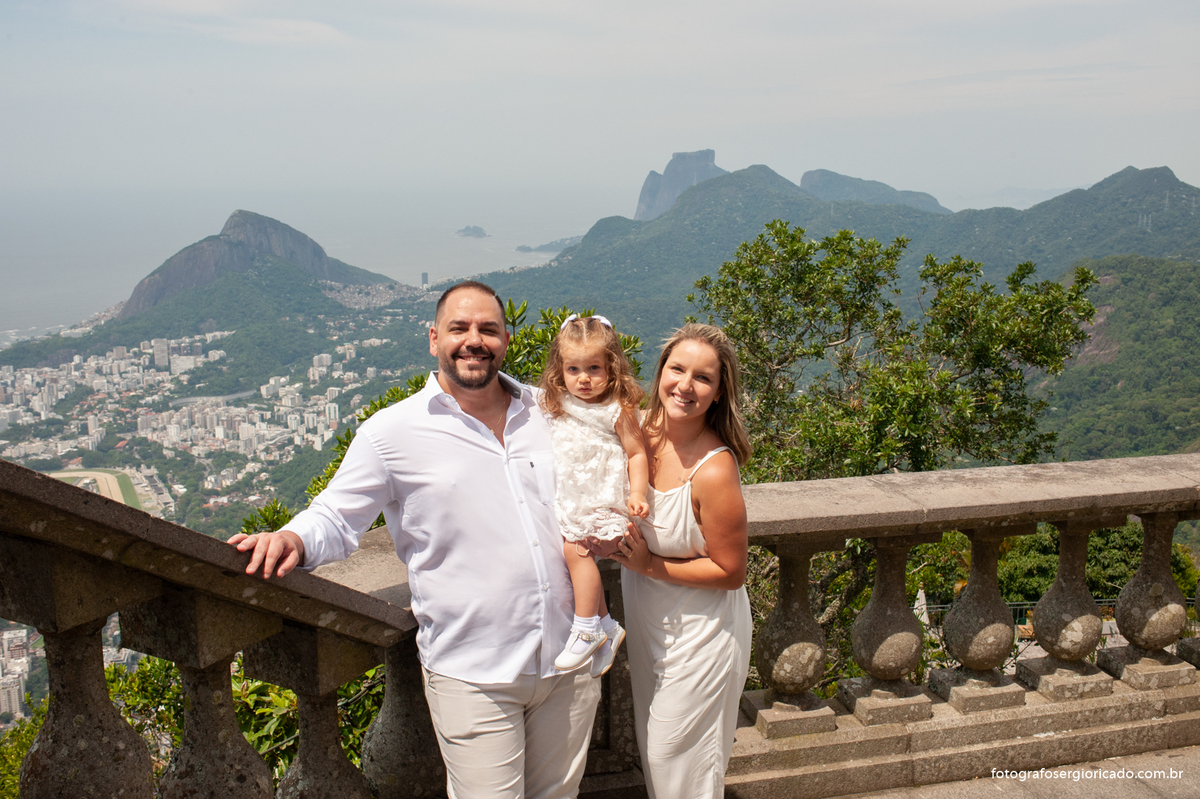 Imagem dos pais com criança batizada na área externa da Capela de Nossa Senhora Aparecida no Cristo Redentor localizado no Morro do Corcovado no Rio de Janeiro