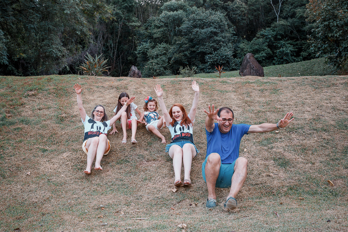 família escorregando na grama