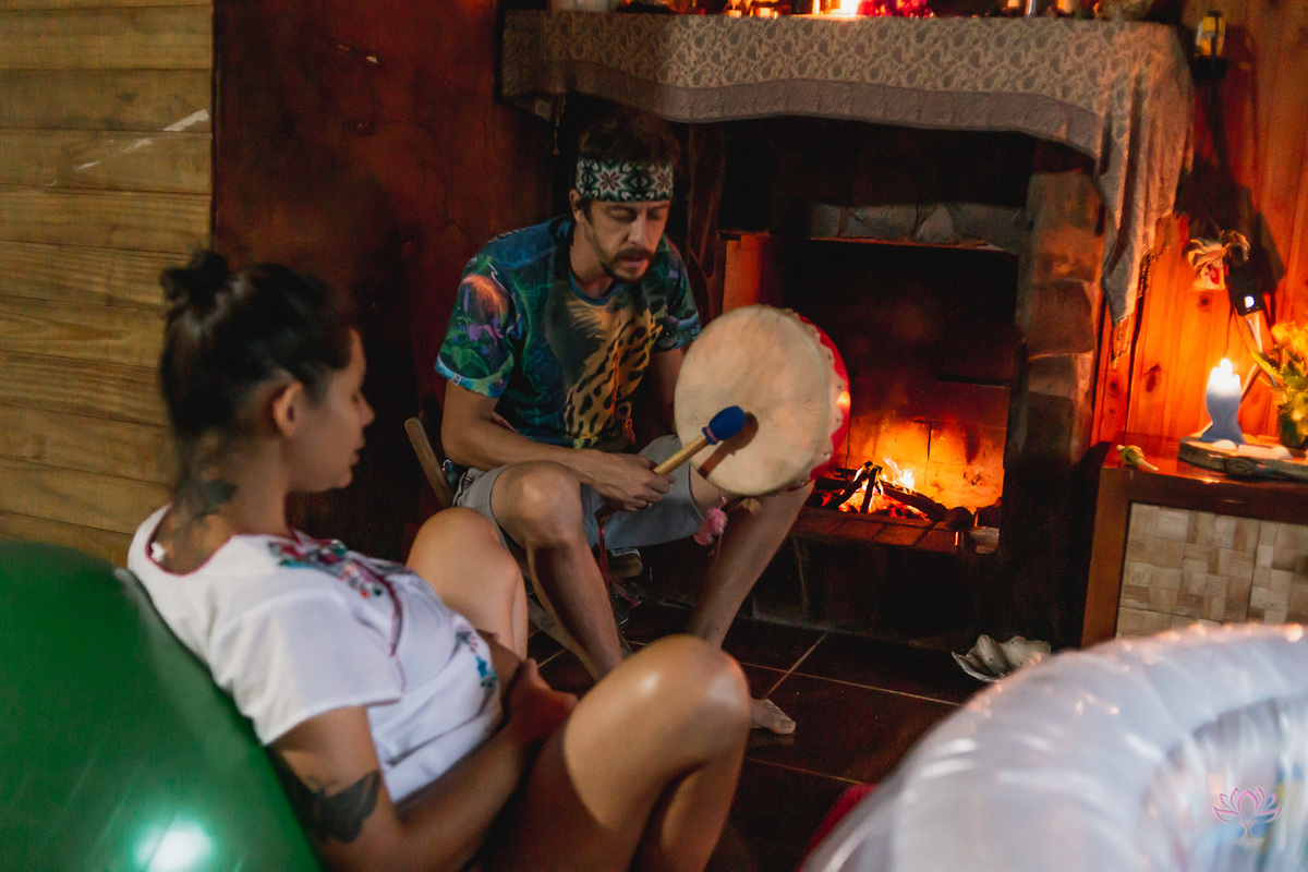 tocando tambor na frente da lareira, mulher grávida