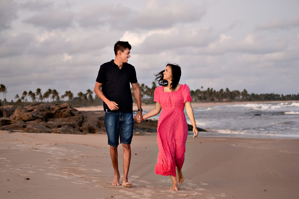 Casal correndo na praia de Itacimirim - Ensaio Pré casamento