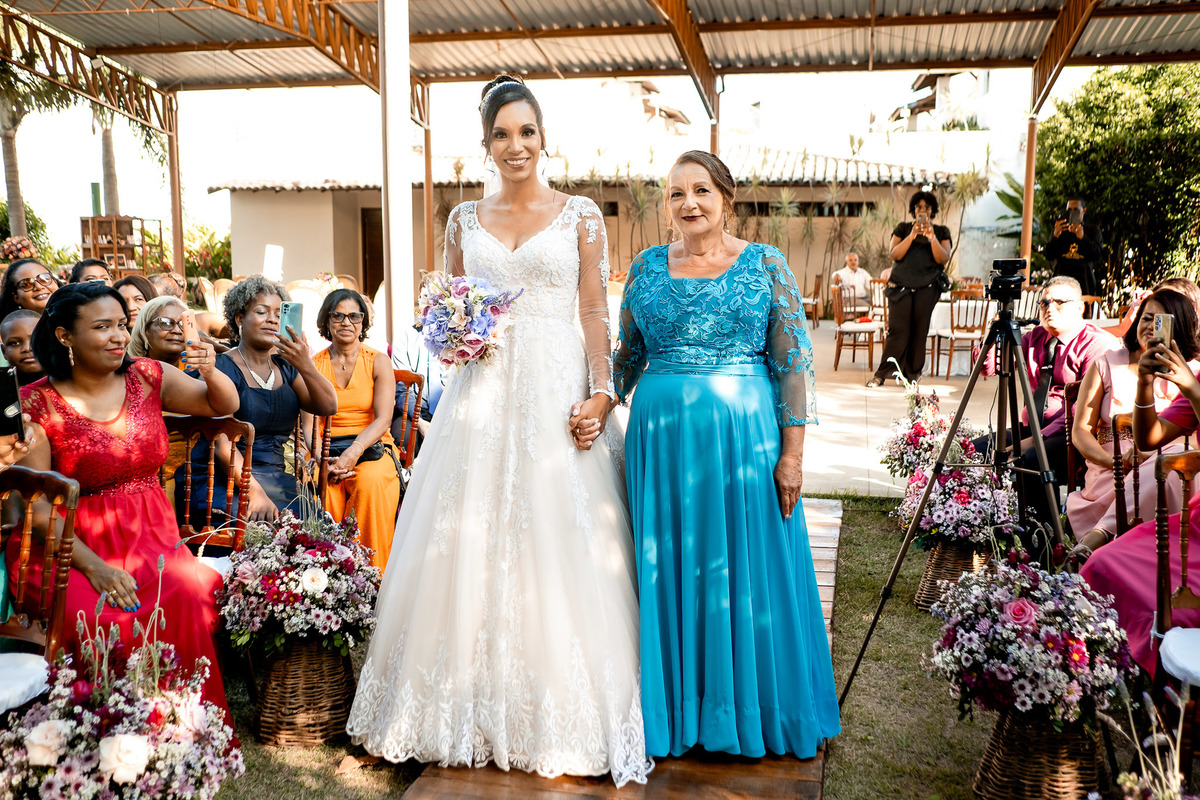 Entrada da noiva no Sítio Canto Verde, casamento em Lauro de Freitas com noiva entrando no corredor com flores.