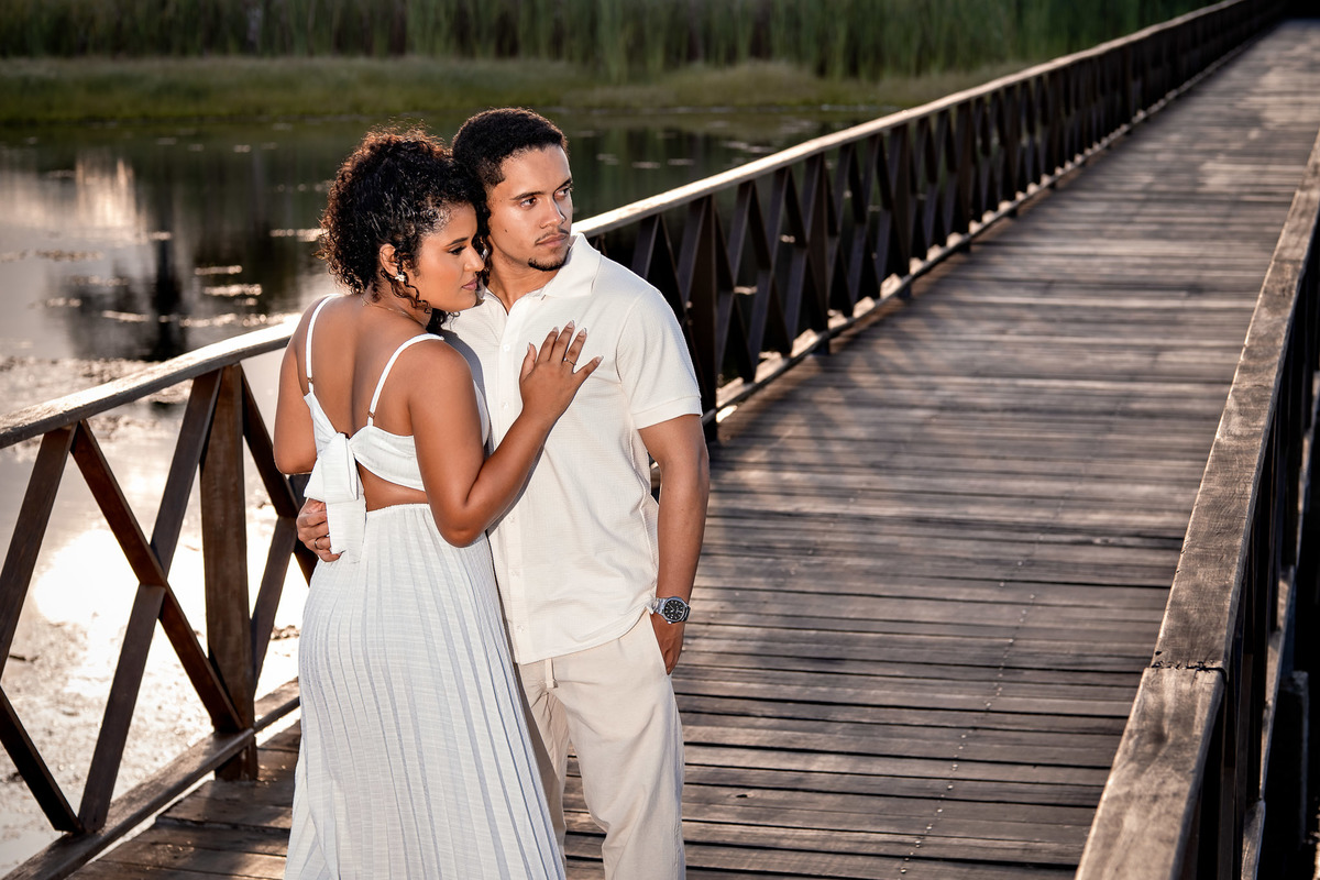 Casal em perfil na ponte de madeira do ensaio pré-casamento na Praia do Forte