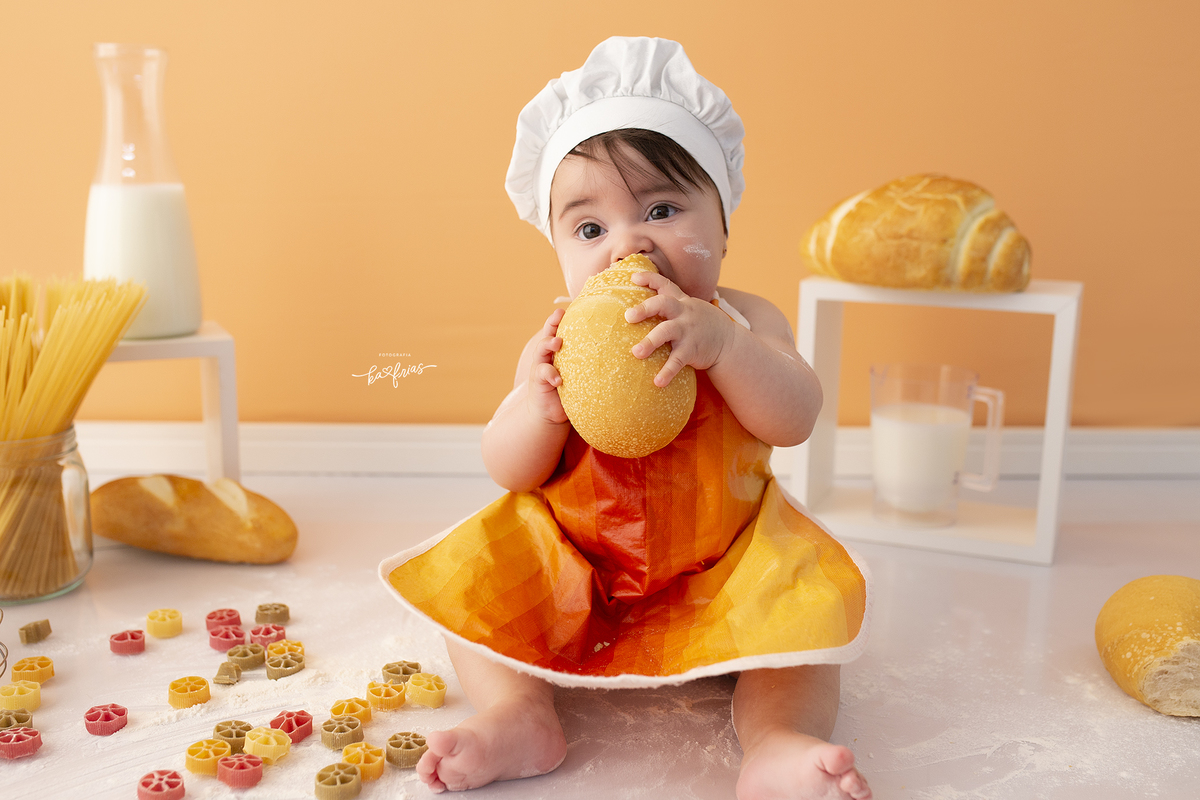 no ensaio infantil a bebe esta comendo pao