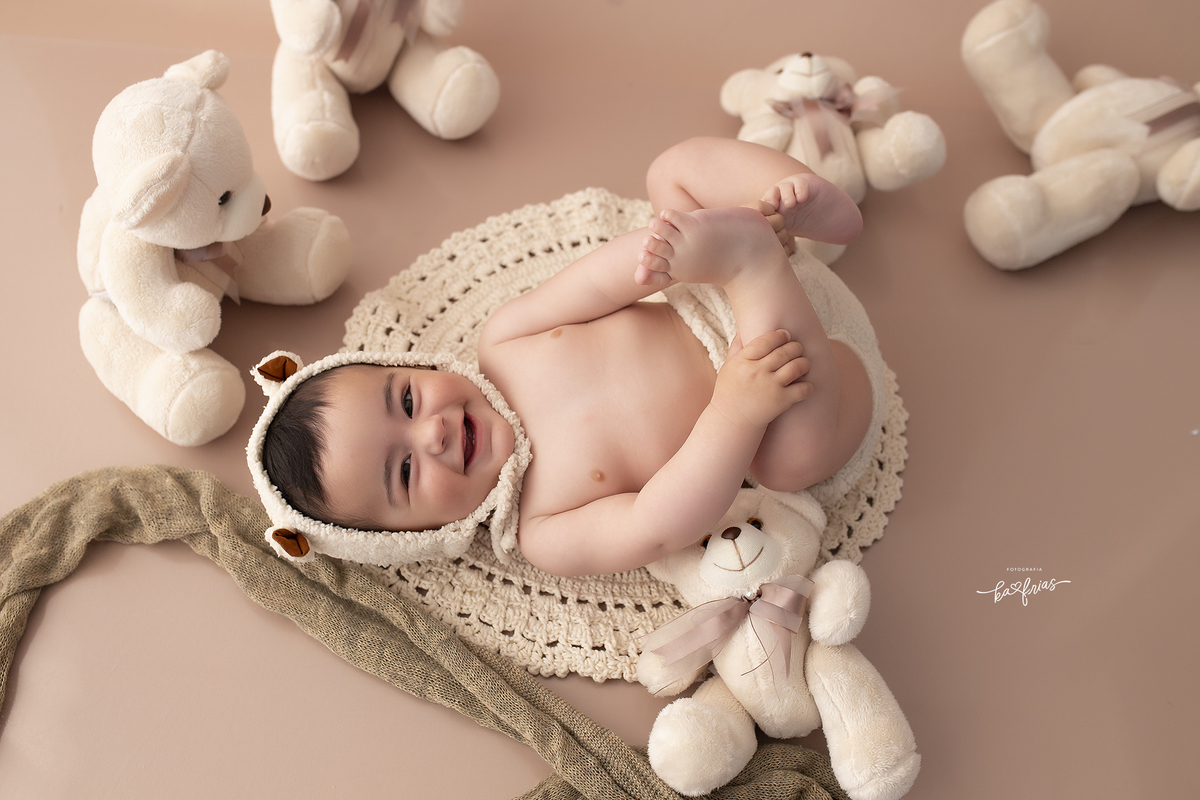 o bebe esta rindo no ensaio de acompanhamento mensal