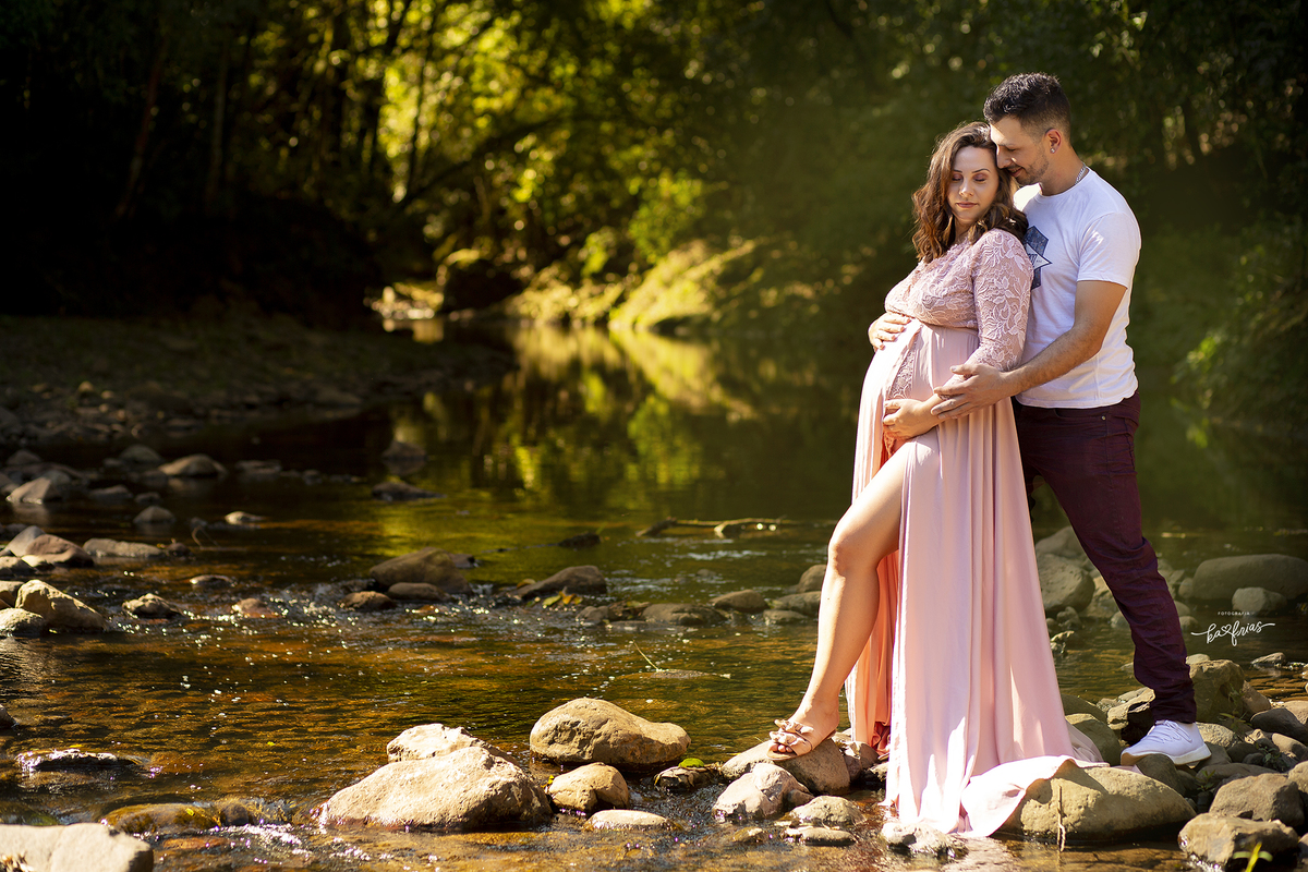 os pais se abraçam no ensaio externo de gestante