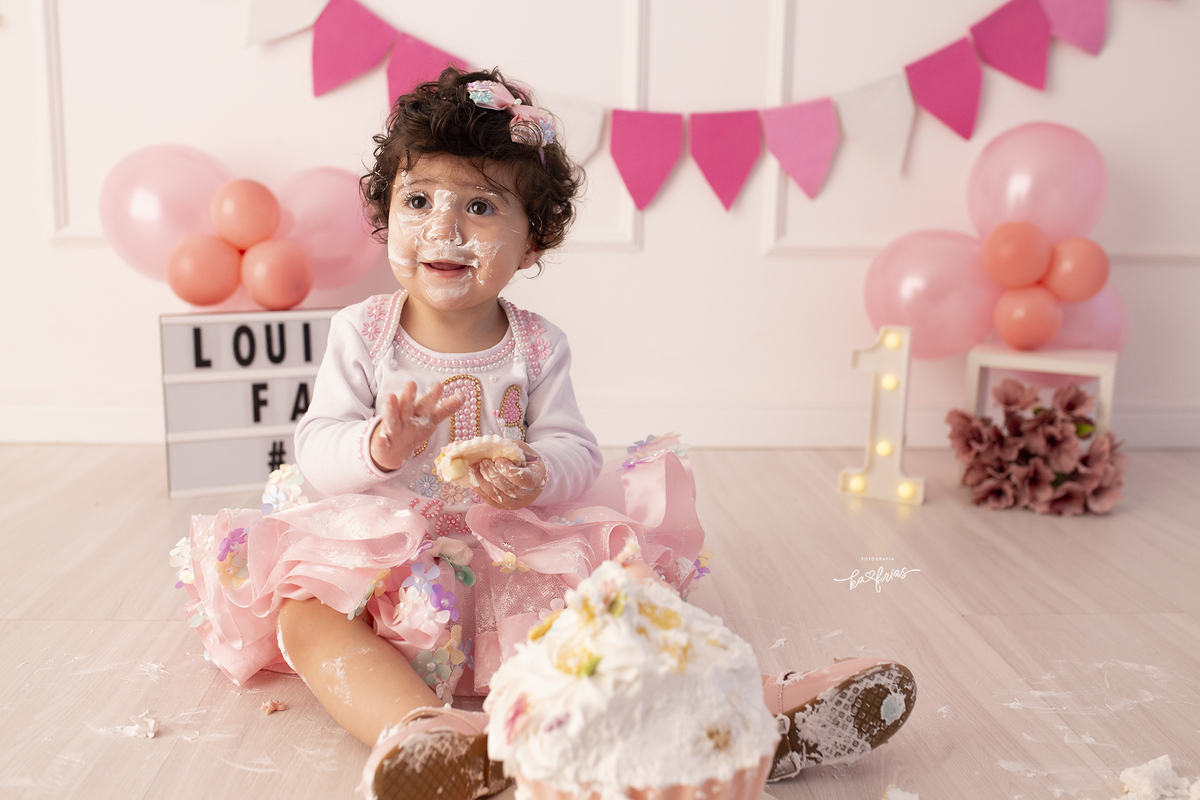 a menina se lambuza com o bolo no ensaio smash