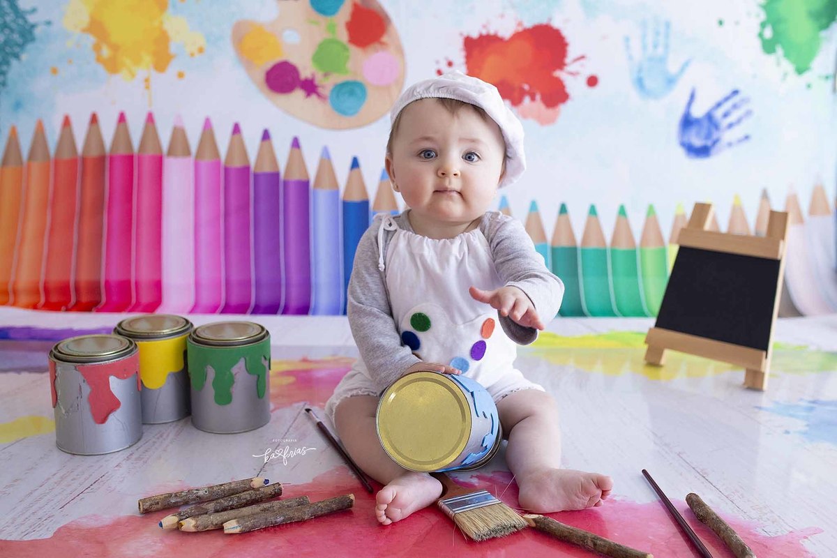 a bebe brinca com as tintas no ensaio de mesversario