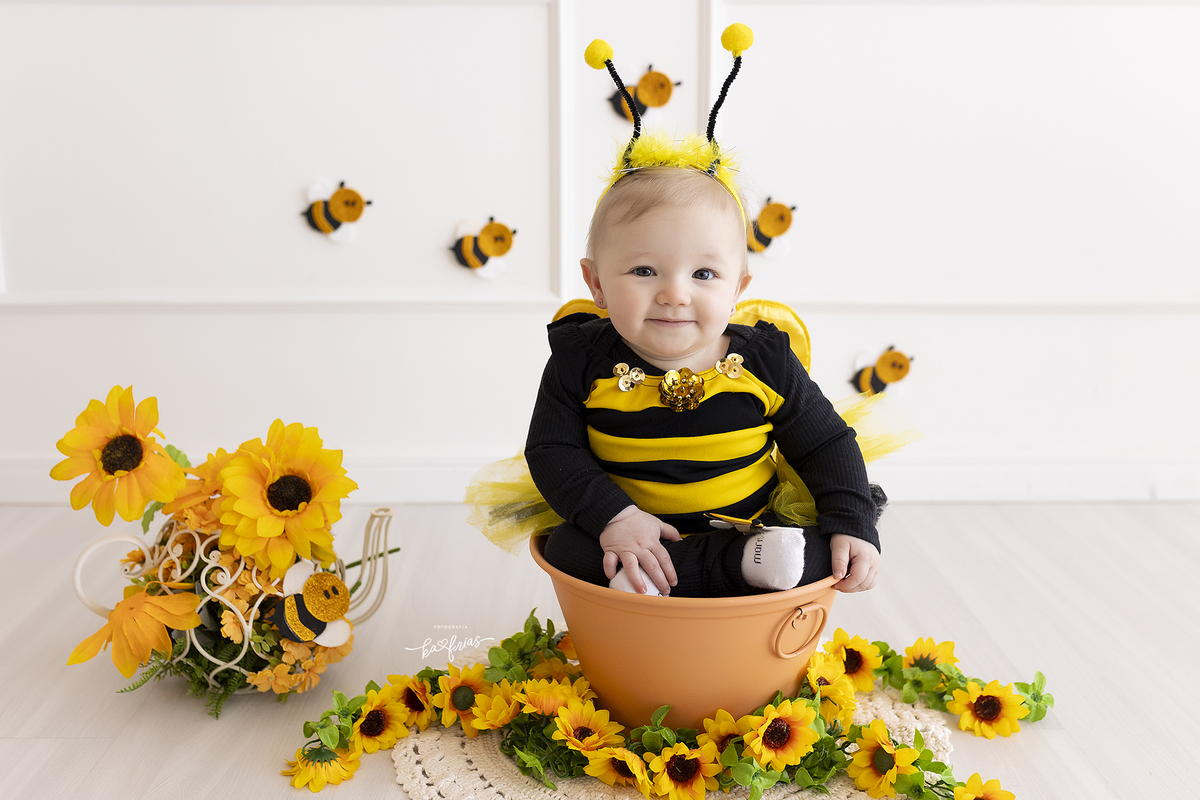 a menina esta vestida de abelha para seu ensaio mensal