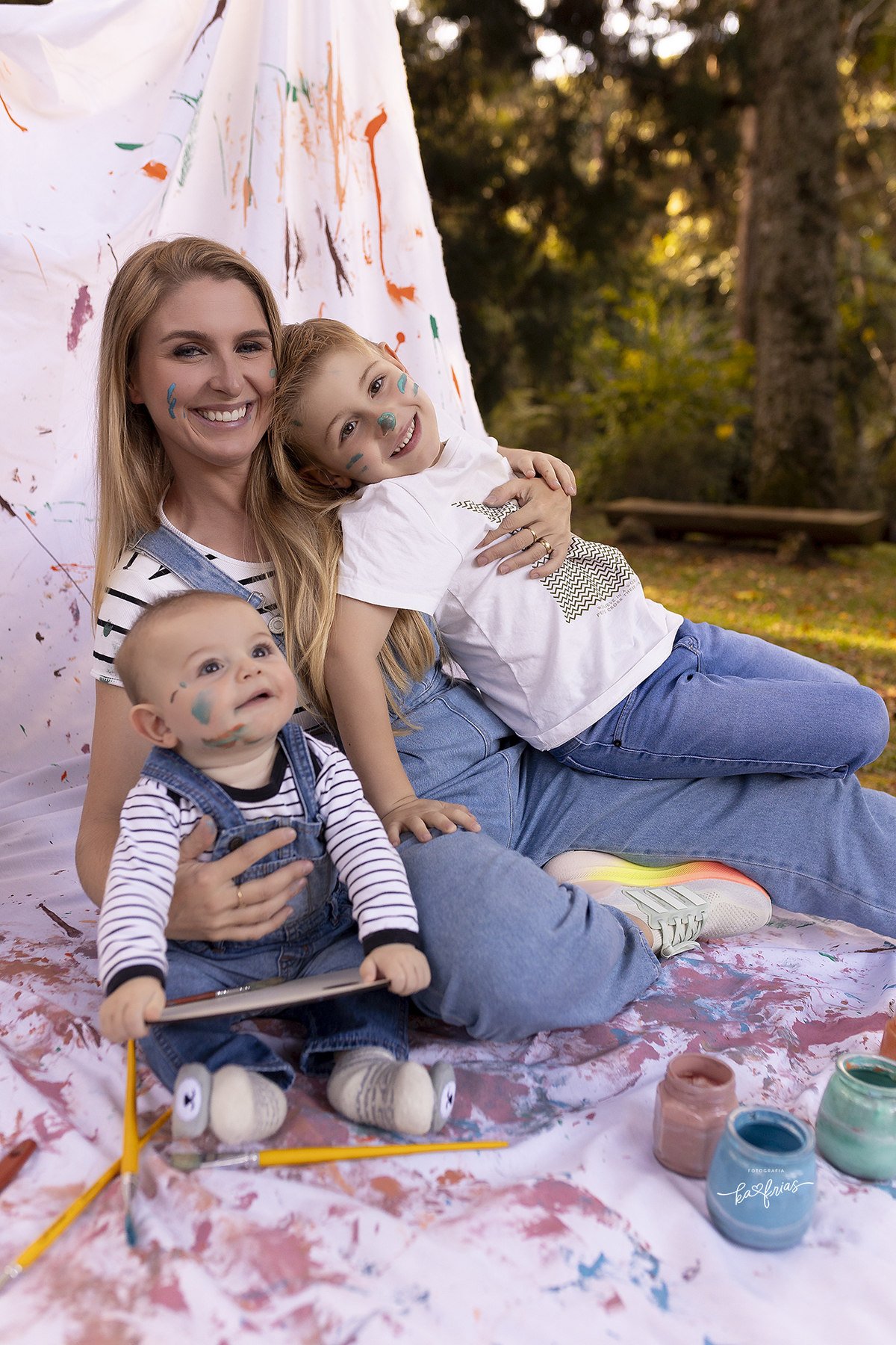 mae e filhos sorriem no ensaio com tinta
