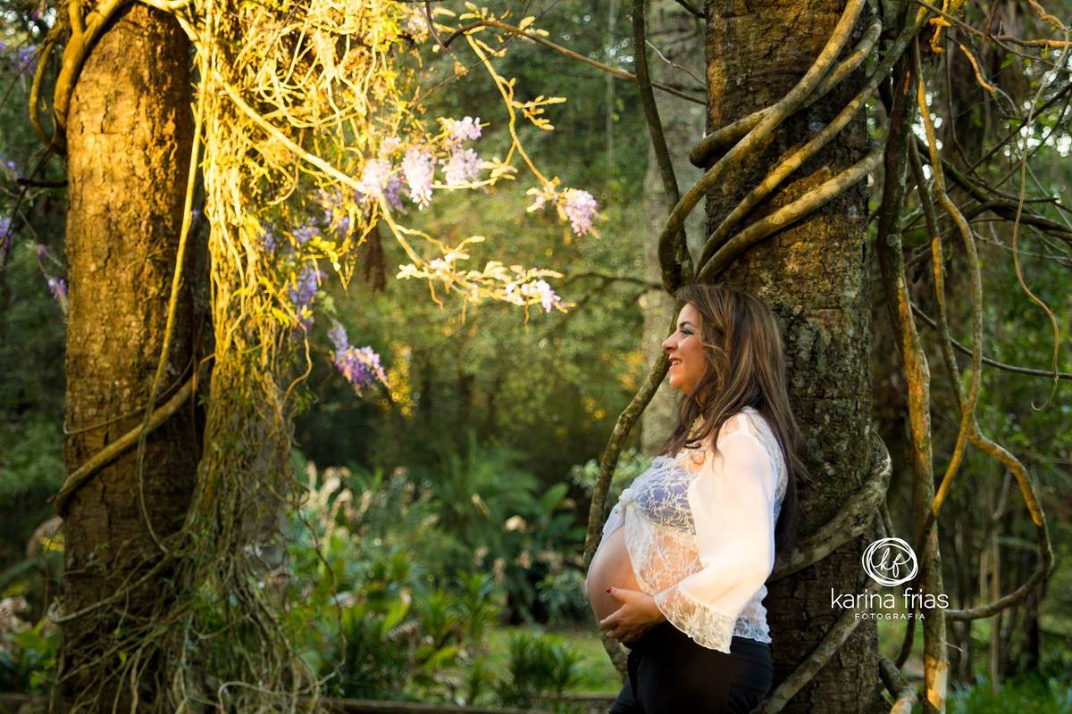 Ana olha o por do sol ao fim do seu ensaio externo de gestante