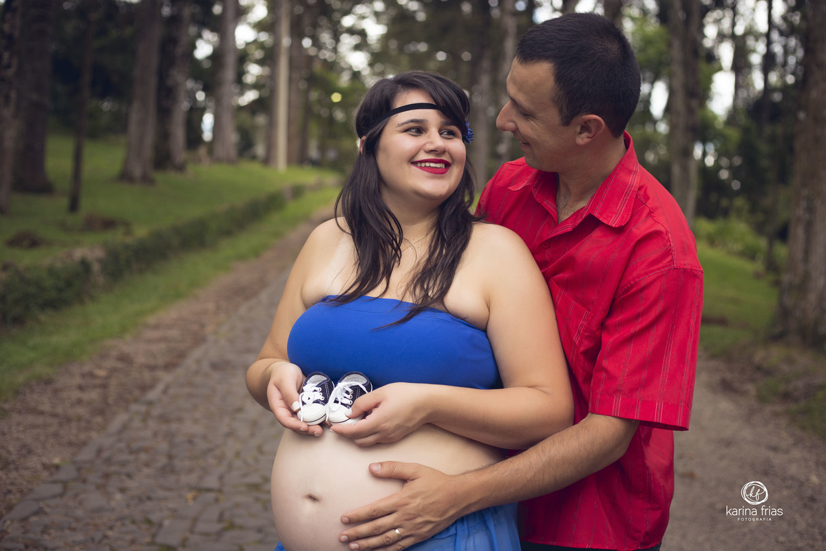 OS PAIS ESTAO SEGURANDO O SAPATINHO PARA AS FOTOS DO BOOK DE GESTANTE