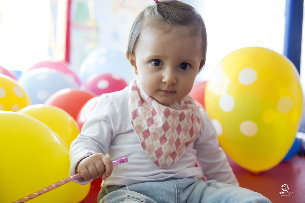 a menina brinca no pula pula enquanto a fotografa de aniversario infantil, karina frias, de caxias do suil, registra o momento