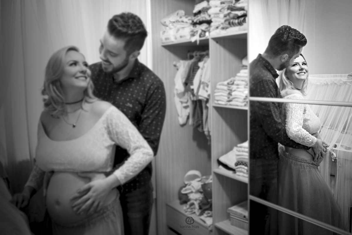 a fotografa de gestante registra os pais no quarto da criança