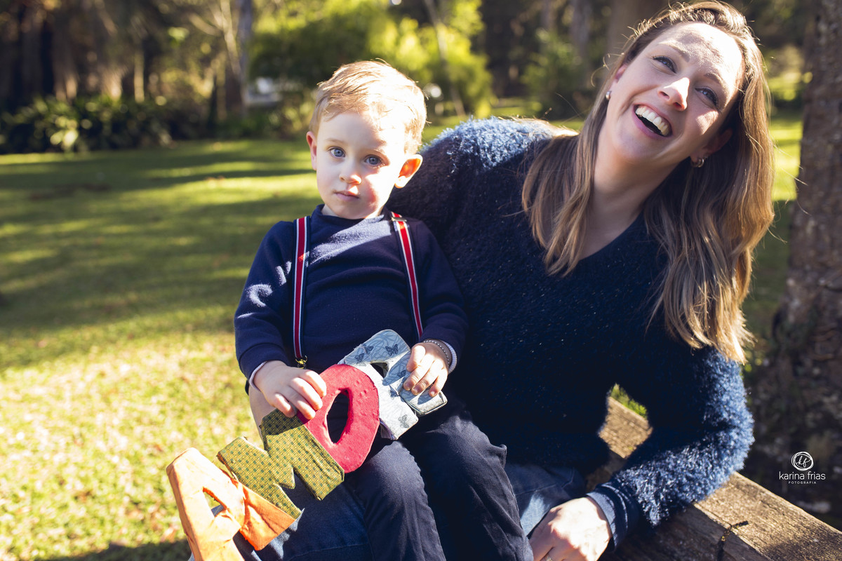 a mae sorri para o filho no ensaio de familia