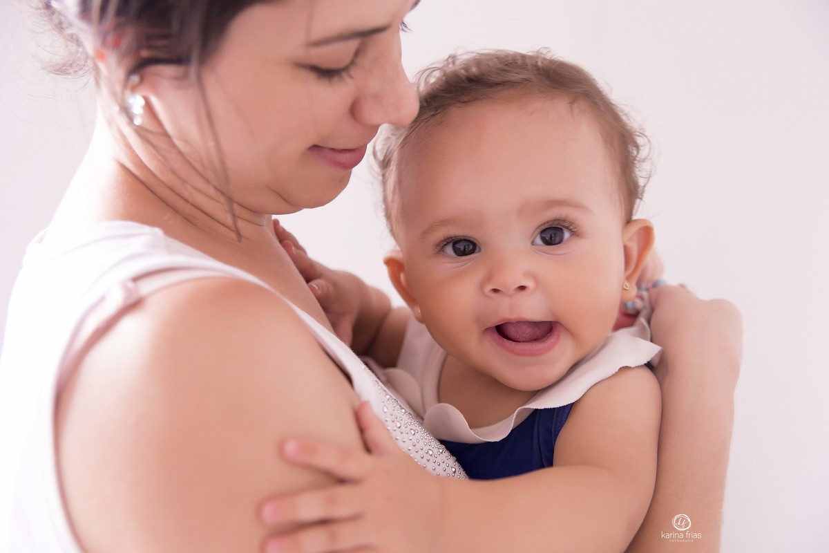 a bebe sorri no colo da mae