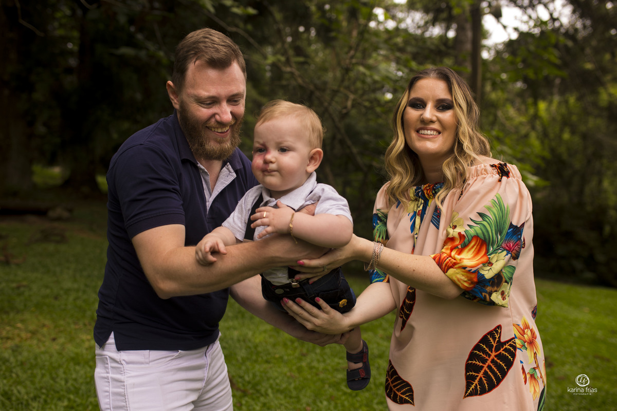 os pais brincam com a criança durante ensaio externo