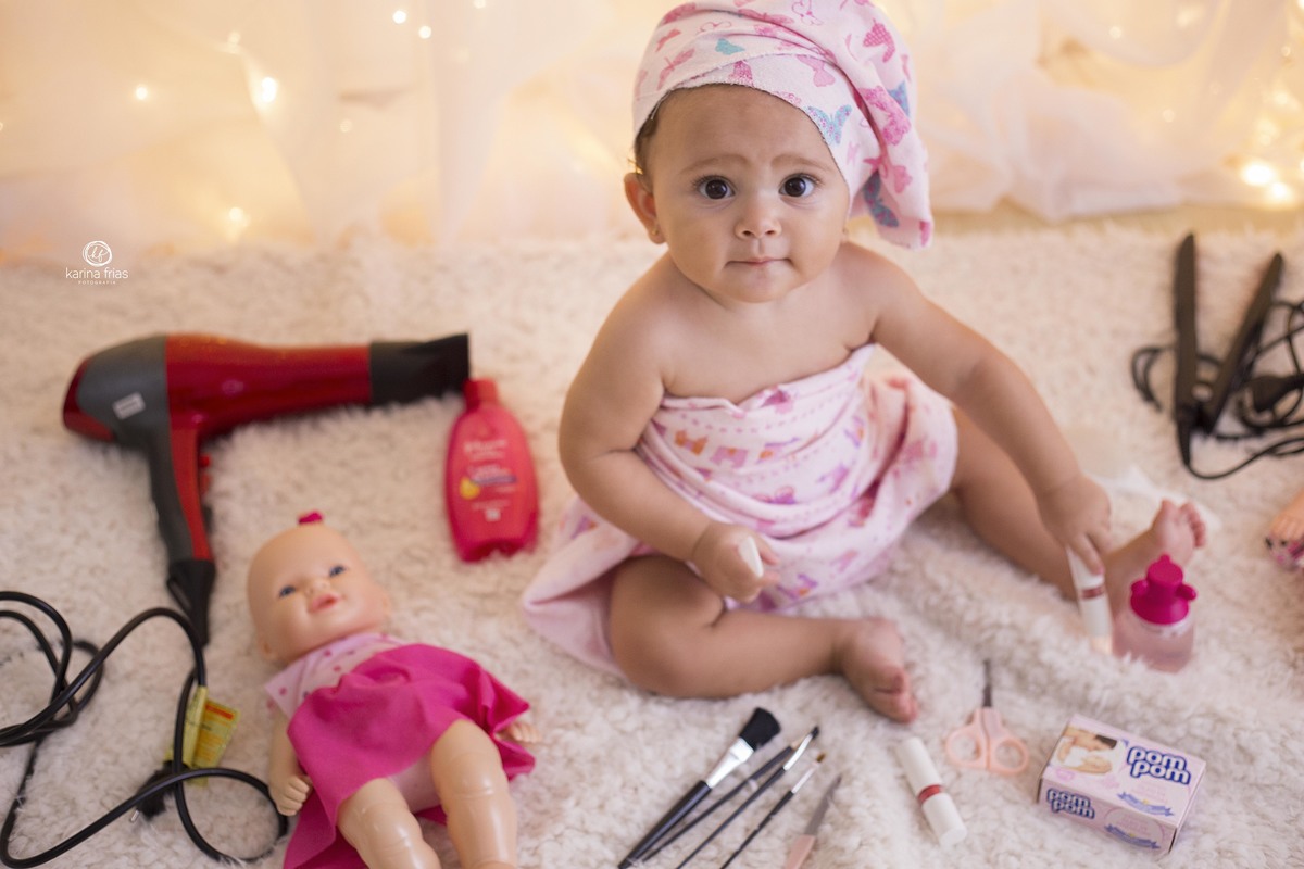 no acompanhamento mensal de bebesa menina brinca com as maquiagens