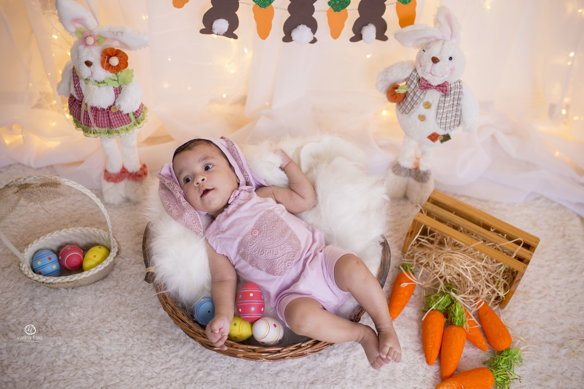 a bebe esta deitada no cenario de pascoa