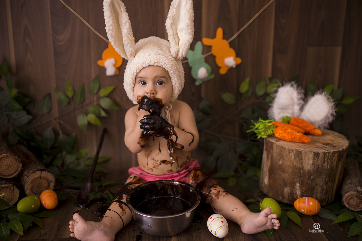 a bebe brinca com o chocolate no ensaio de pascoa do estudio
