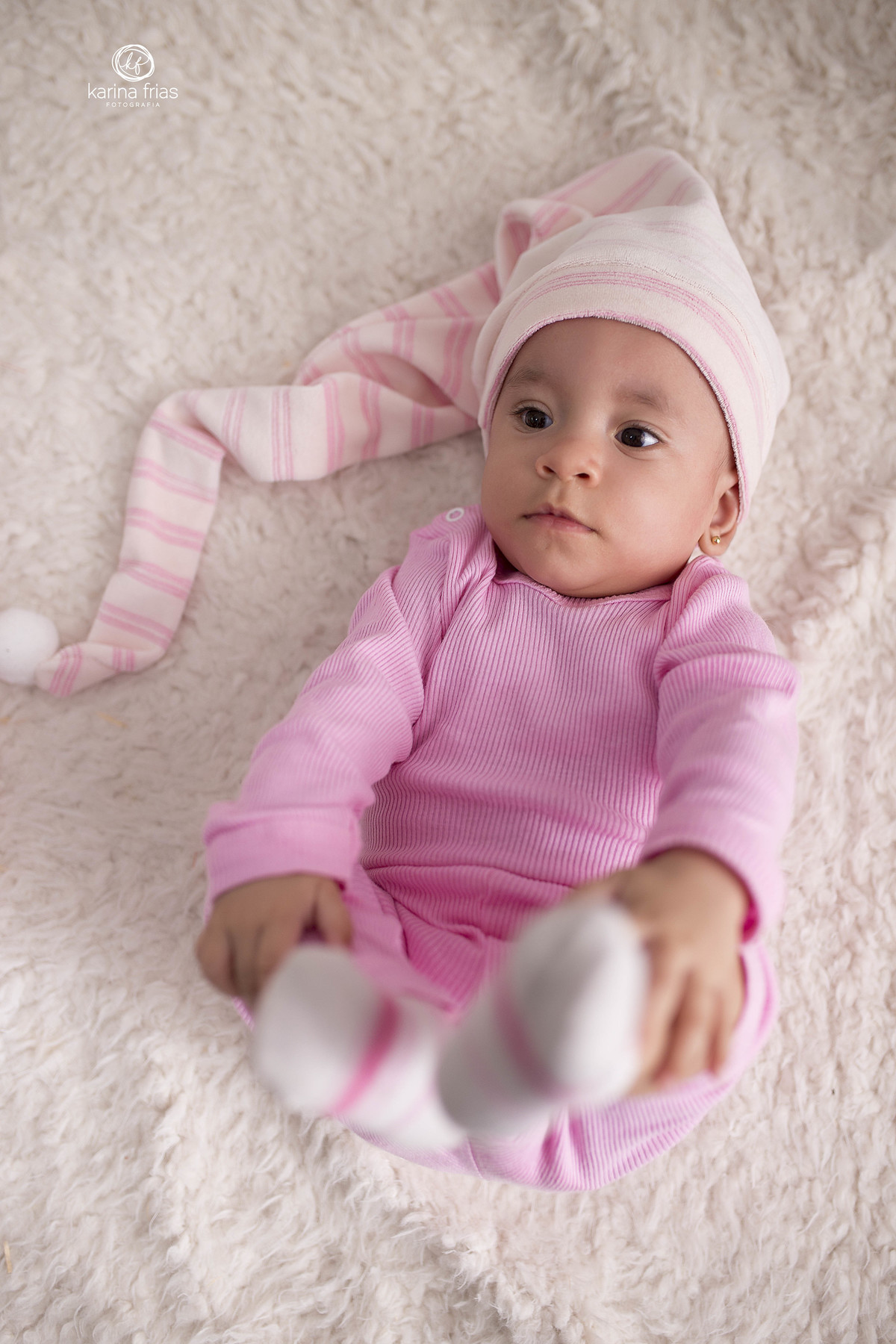 no ensaio de acompanhamento mensal a bebe segura os pes