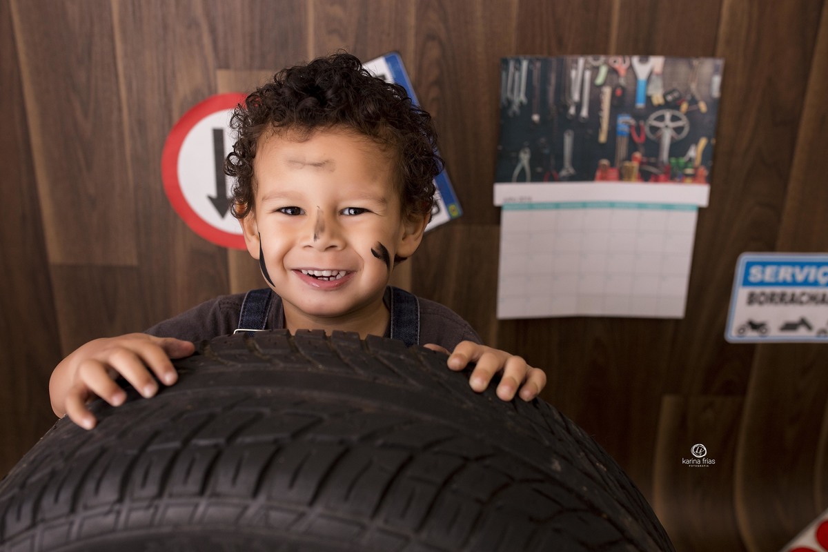 a crianca esta atrás do pneu no ensaio infantil