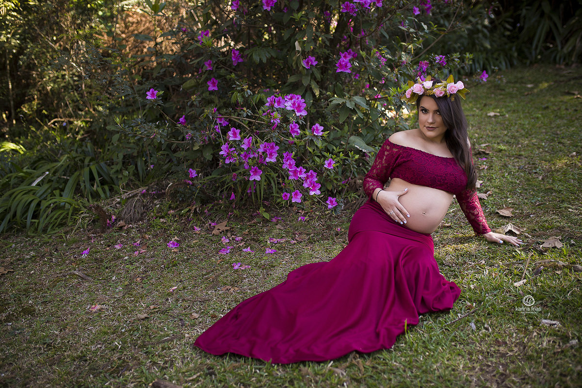 no ensaio de gestante, a modelo esta sentada no chao