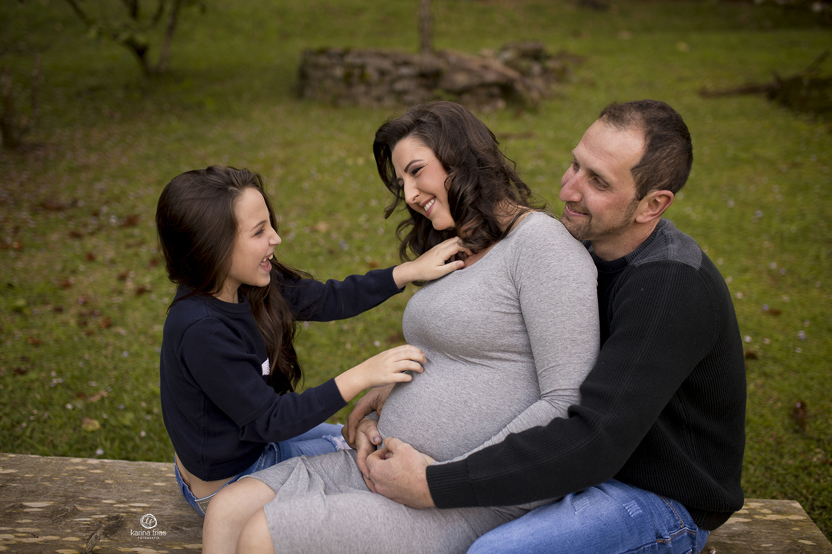 a familia brinca durante sessão de fotos de gestante