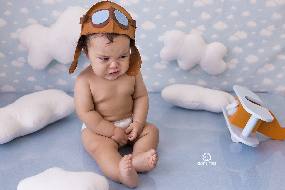 o bebe chora durante as fotos no cenario de aviador