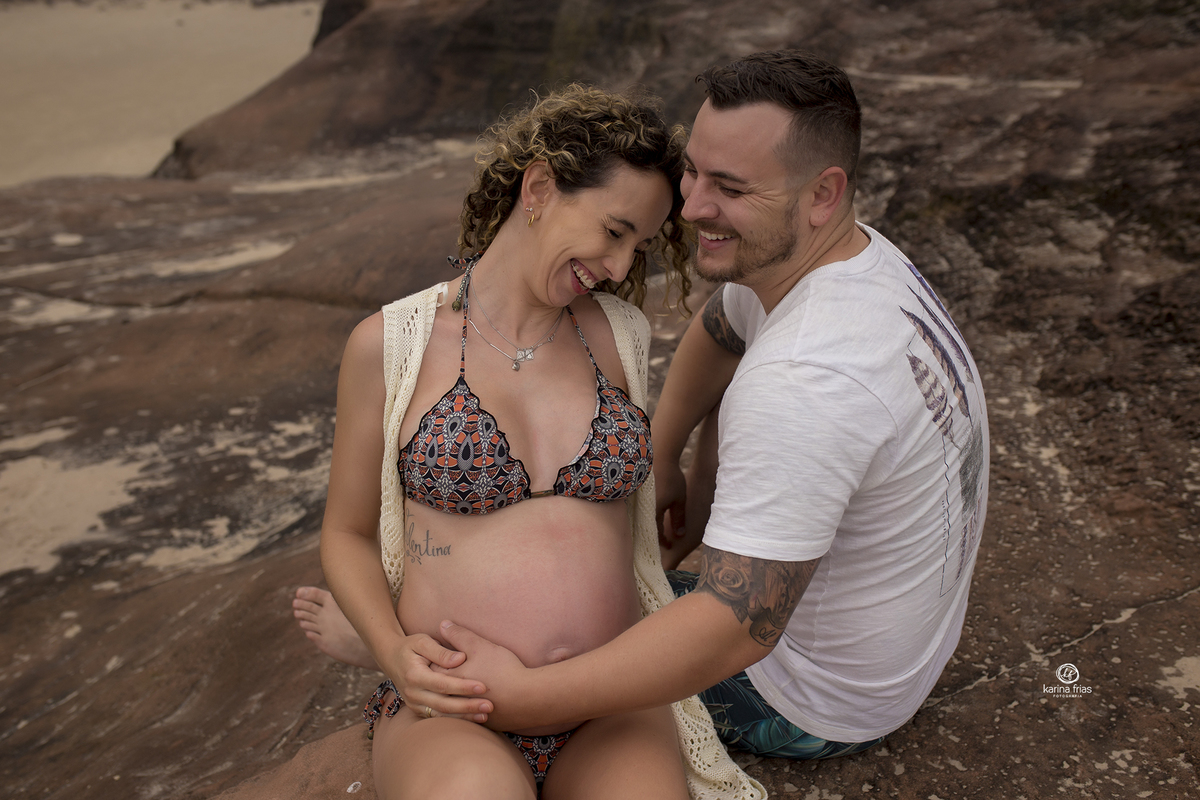 os pais sorriem no ensaio de gestante externo