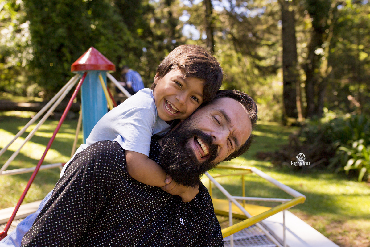 o menino abraça o pai que brinca com ele
