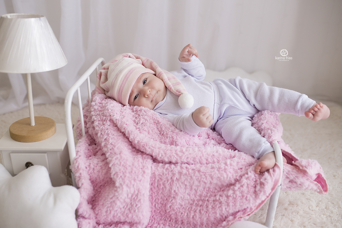 a bebe esta deitada na caminha para a sessão de acompanhamento