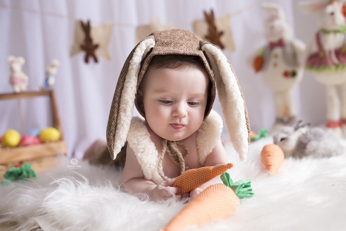 o menino brinca com a cenoura durante ensaio infantil