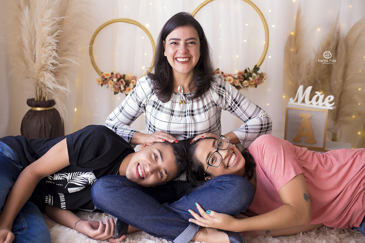 no ensaio de dia das maes, os filhos deitam no colo da mae