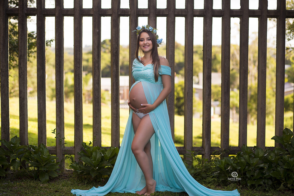 a gestante sorri durante sessão de fotos externas