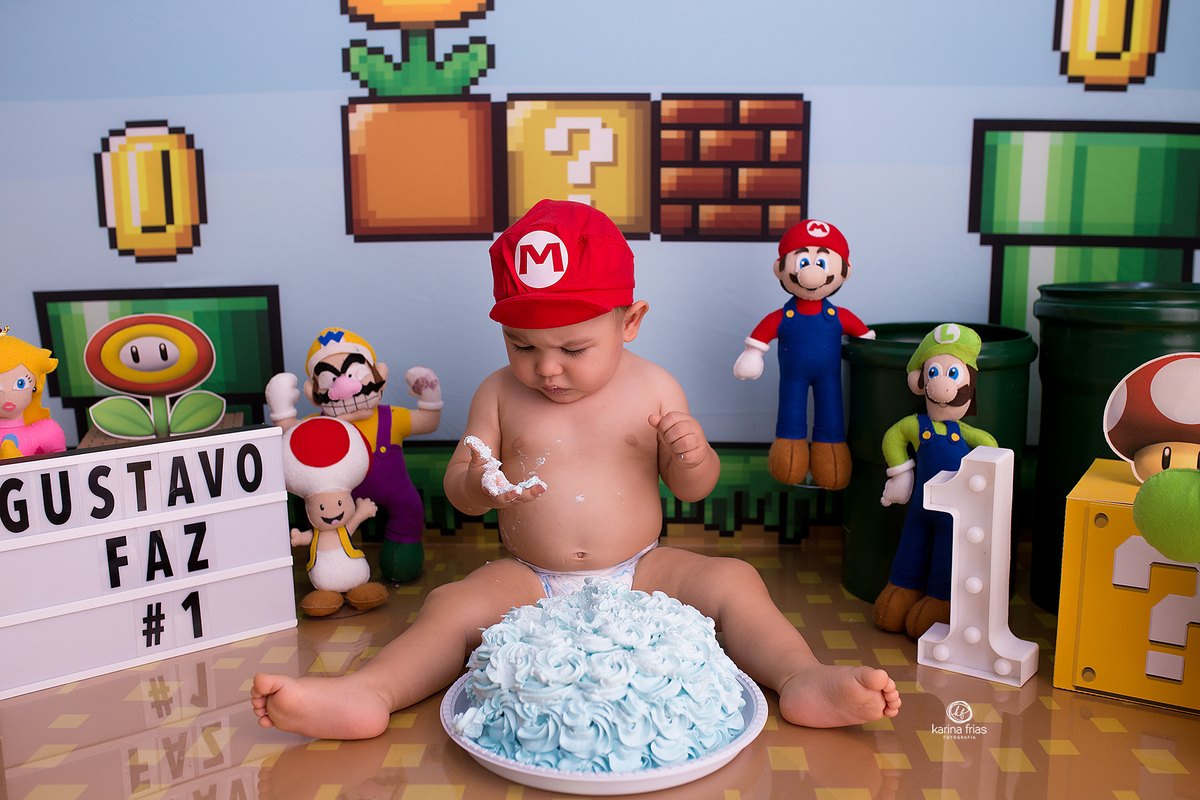 o menino olha para a mao suja de bolo