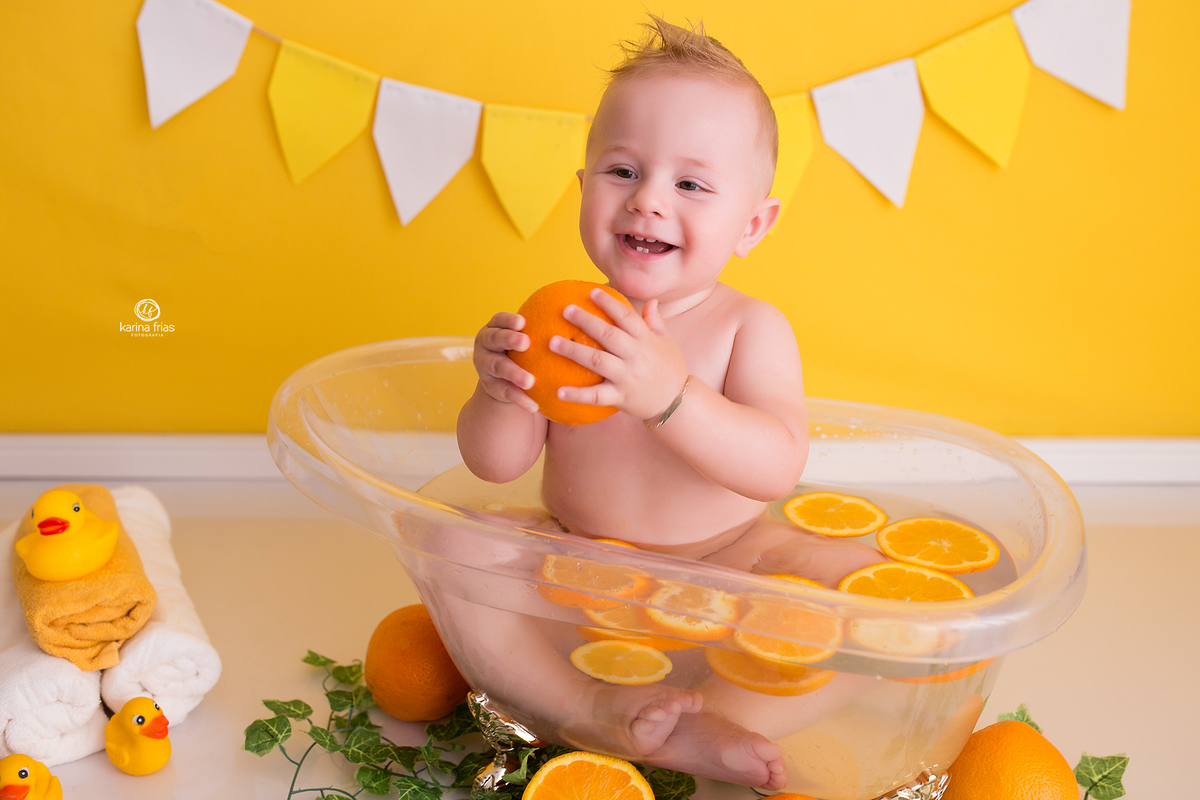 o menino segura a laranja durante ensaio