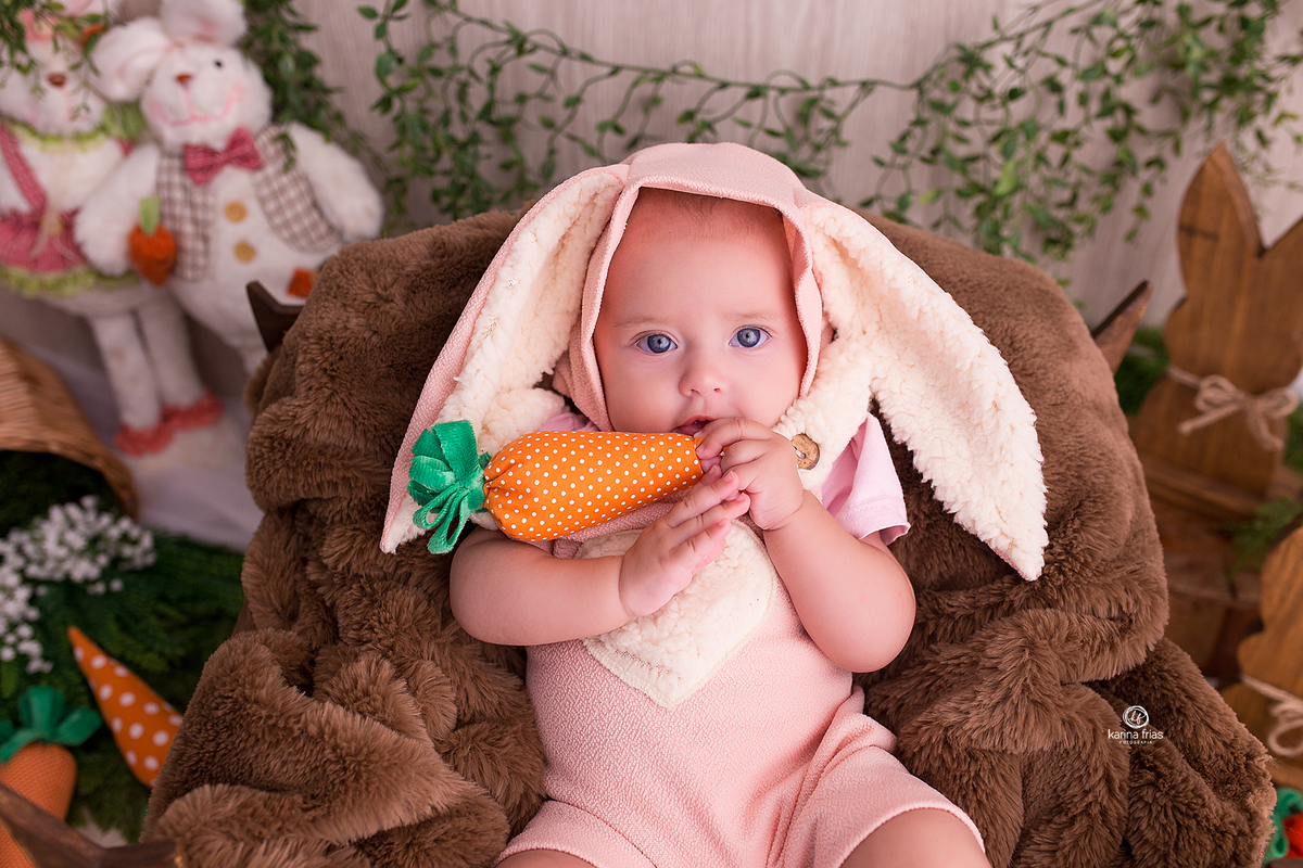 a bebe poe a cenoura na boca durante sessão de pascoa 2021