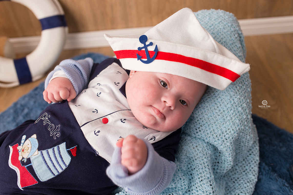 no ensaio infantil o bebe olha para a fotografa de bebes de caxias do sul, karina frias